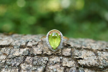 Jewelry ring decorated with chrysolite. Close-up subjects.