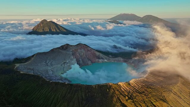 Hyperlapse aerial view flying to mountain Kawah Ijen wtih smoke coming out of volcano crater during sunrise, Java, Indonesia 