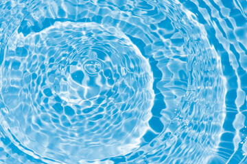 Defocus blurred transparent blue colored clear calm water surface texture with splashes reflection. Trendy abstract nature background. Water waves in sunlight with copy space. Blue watercolor shine.