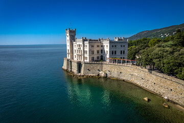 An aerial of the Miramare Castle in the scenic Gulf of Trieste in Italy captured on a bright day