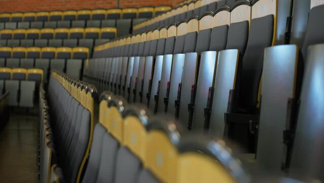 Orbiting close up of empty seats at hockey arena