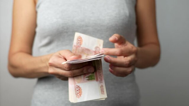 Close-up of woman hands counting russian money