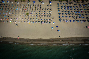 Aerial drone view of Spille beach in Albania with pine forest