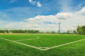 Green synthetic grass sports field with white line shot from above. background