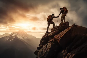 Foto op Canvas Mountaineer helping friend to the summit of a mountain at sunset © David