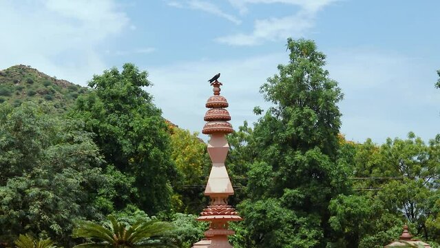 artistic jain red stone holy pillar at morning from unique angle video is taken at Shri Digamber Jain Gyanoday Tirth Kshetra, Nareli Jain Mandir, Ajmer, Rajasthan, India.