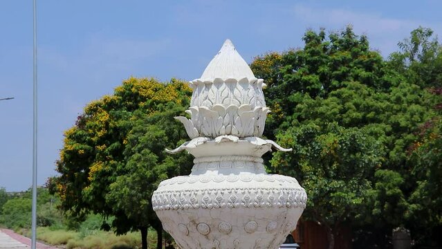 artistic white marble jain temple holy pillar with bright blue sky at morning from unique angle video is taken at Shri Digamber Jain Gyanoday Tirth Kshetra, Nareli, Ajmer, Rajasthan, India.