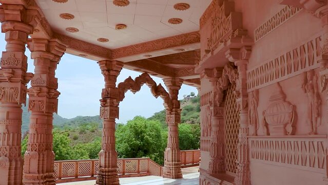 artistic hand carved red stone jain temple at morning from unique angle video is taken at Shri Digamber Jain Gyanoday Tirth Kshetra, Nareli Jain Mandir, Ajmer, Rajasthan, India.
