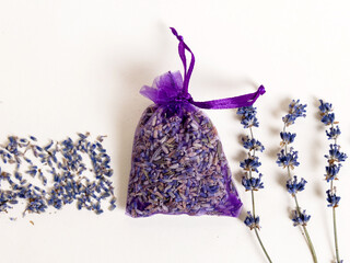 lavender handmade soap isolated on light background, on bed sheet with flowers and purple sack for sleeping improvement.soap on woman hand, woman holding bouquet.minimalist product photography.