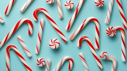 Foto op Canvas Christmas candy canes on a blue background, top view © Dennis