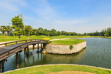 Beautiful green golf course and beautiful pond.