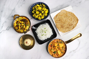 Indian vegetarian Thali or platter includes Aloo ki sabji, dal rice, Roti bhaji, Matar Paneer,...