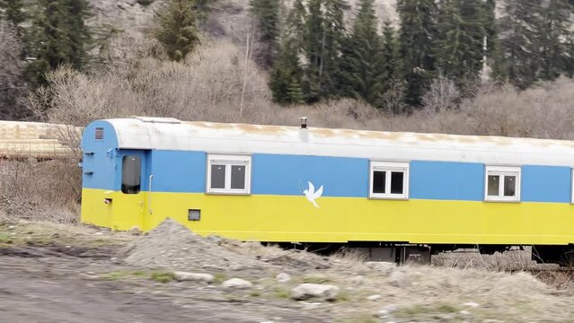 Ukrainian train cart painted in Ukrainian colors with Pidgeon of peace.