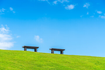 Two chairs empty on green grass at park in nature forest Mountain views spring bright blue sky weather nature abstract clear texture with white clouds summer light sun day.