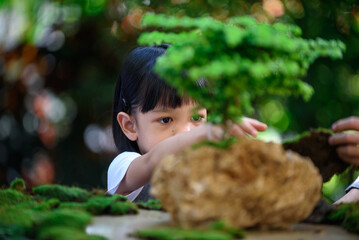 Young boy and girl make a little plant garden