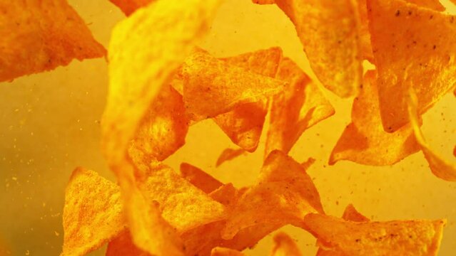 Super slow motion of flying tortilla chips on color gradient background. Filmed on high speed cinema camera, 1000 fps. Camera placed on high speed cine bot, tracking the target.