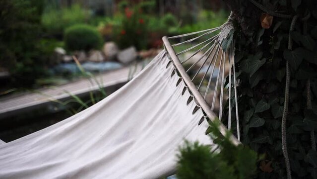 hammock in the garden swings in the wind, outdoor recreation 