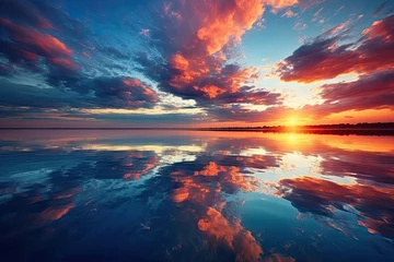 Foto op Aluminium Sunset over the horizon with beautiful clouds and reflection in the water © PinkiePie