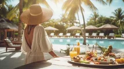 Muurstickers Healthy woman on swimming pool in luxurious tropical resort with have various food and drinks on table, Beach luxury lifestyle in summer vacation. © Oulaphone