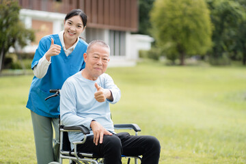Elderly care concept. Portrait of nurse and her senior client on wheelchair.