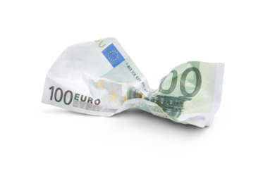 A crumpled 100 Euro banknote lying on the ground after being thrown away, dropped, wasting money concept isolated against a transparent background.