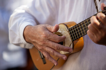 Close-up of a Canarian man playing a traditional timple (small guitar)