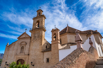 Antequera town in Andalusia. Old city homes and church on a beautiful sunny day