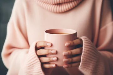  female holding a cup of hot drink close up © Elena