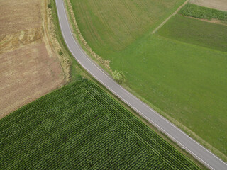 View from above of a road between country fields in the countryside 
