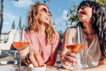 smiling ladies enjoy quality time having conversation and drinking wine