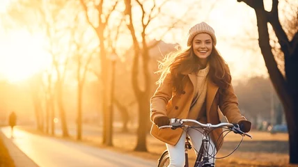 Foto op Plexiglas Pretty young woman on bicycle in an autumn park at sunset. Outdoor fashion portrait of elegant lady riding her hipster retro bike in stylish clothes.  © BlazingDesigns
