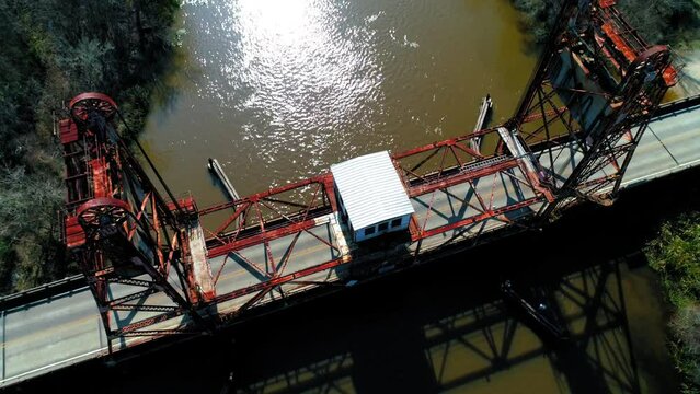 Aerial Tilt Down Shot Of West Pearl River Bridge Over River Amidst Trees On Sunny Day - New Orleans, Louisiana