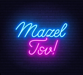 Mazel Tov neon lettering on brick wall background.