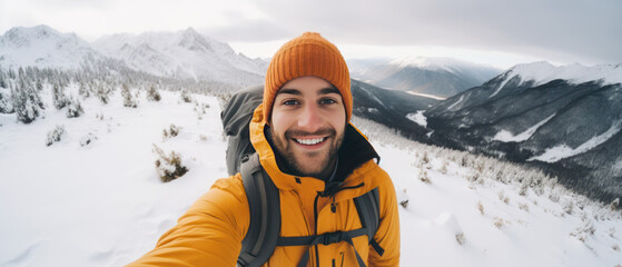 Fototapeta premium Young Man Taking Selfie in Winter Snow Mountain