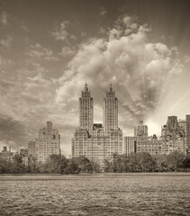 New York City at sunset. Panoramic view of Manhattan buildings from Central Park Lake