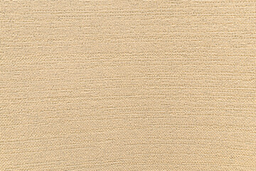 Jute hessian sackcloth canvas woven texture pattern background in light beige cream brown color.