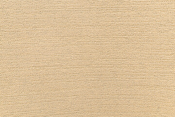 Jute hessian sackcloth canvas woven texture pattern background in light beige cream brown color.