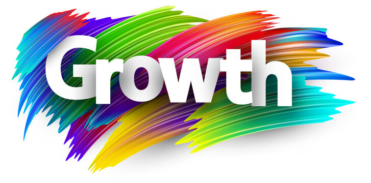 Growth paper word sign with colorful spectrum paint brush strokes over white.