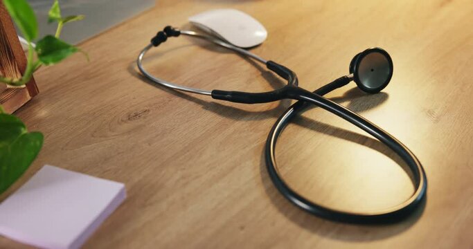 Stethoscope, medical tool and hospital desk at a doctor office and clinic for consultation. Healthcare, professional and sticky notes with computer mouse for cardiology or health worker at table