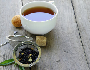 natural tea in a cup with fresh berries and mint