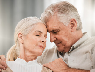 Old couple, hug and forehead touch, relax on sofa with love and support, bonding while at home with trust and comfort. People together in marriage, partner and retirement with calm and peace of mind