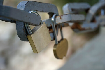 Many padlocks closed on bridge fence - love concept