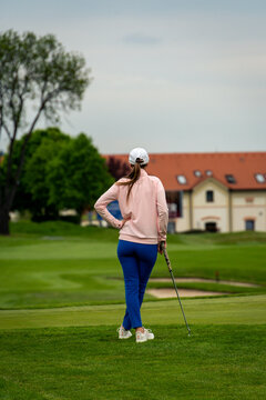 Young women gracefully golfing on a serene course, enjoying a sunny day filled with leisure and sport, perfectly capturing the essence of outdoor recreation.