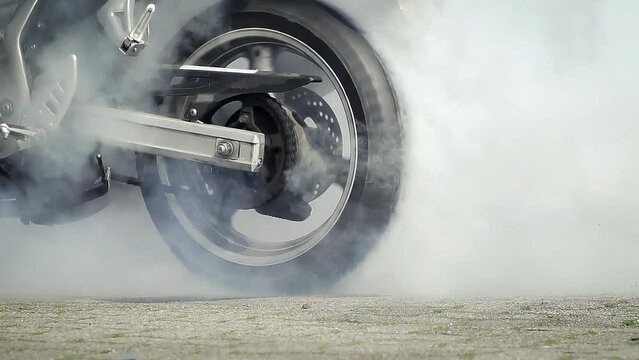 Motorbike burnout, Biker on a motorcycle drifts in smoke, burns tire on a motorcycle.