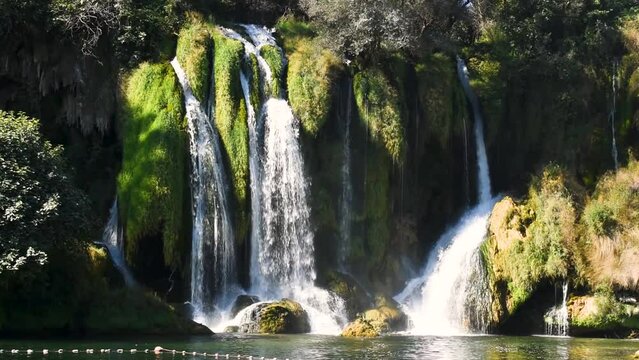 Part of Kravica waterfall during sunny summer day