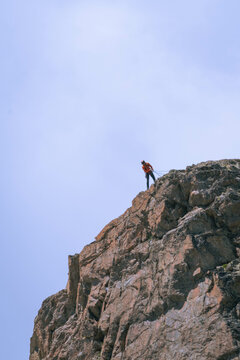 Courageous climber scaling the majestic Swiss Alps, conquering heights and embracing the thrill of high-altitude adventure.