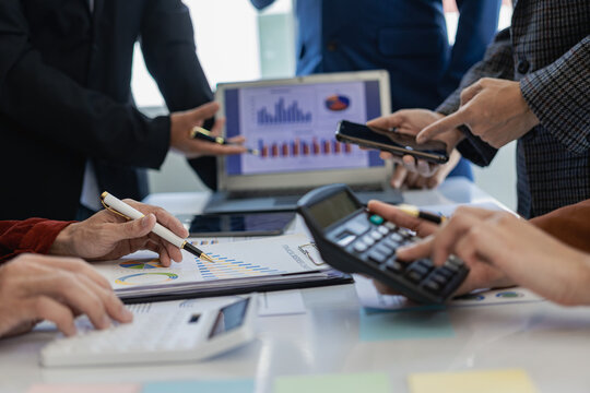 Group meeting of business people in the office Businessman and office worker working in a team meeting with project planning documents on the conference table. Close-up pictures