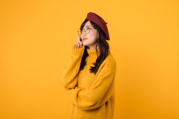 A charming young lady in her 30s, wearing a red beret and eyeglasses, deep in thought against a...