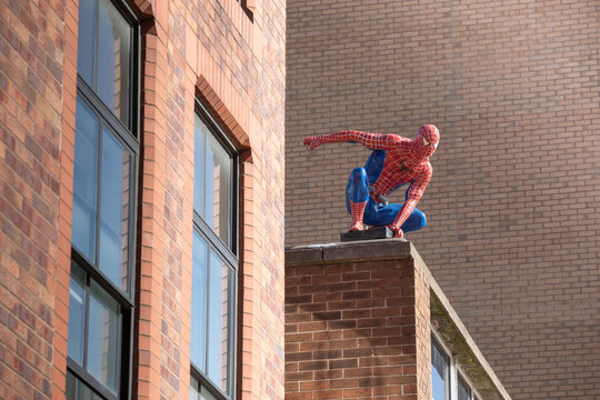 Sheffield, United Kingdom - September 21, 2023: Life-size Spider-Man figure on the rooftop in Sheffield city centre.