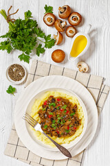 potato mash topped with mushroom gravy in bowl